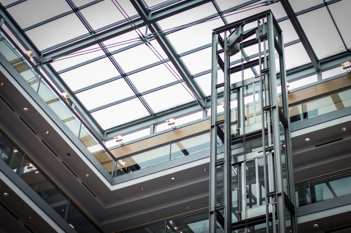 Modern transparent lift installed in a commercial building in Dubai, meeting UAE safety standards