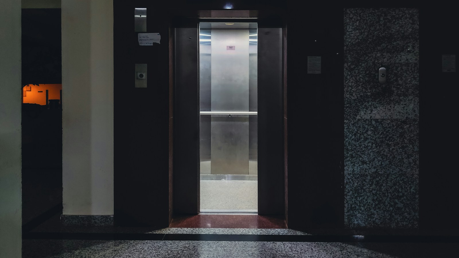 Modern elevator cabin interior with open doors in a commercial building